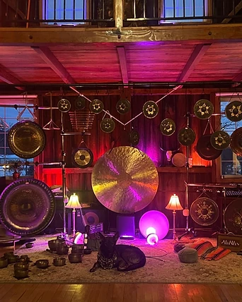 A gong altar lit in magenta with a dog at rest