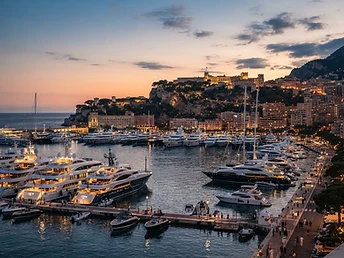 Monaco harbor with superyachts at sunset