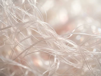 Macro abstract of translucent pearlescent fibrous strands