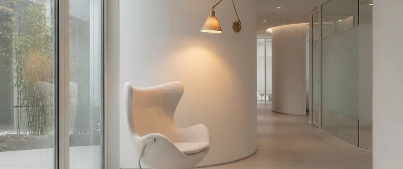 A serene, modern clinical interior with curved white architecture