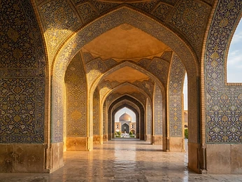 Mosque arches with geometric patterns in golden light