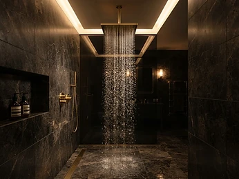 A rain shower in a dark marble bathroom