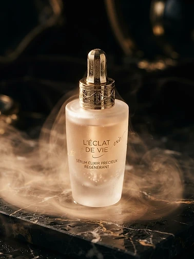 Frosted glass Comfort Essence bottle on veined black marble