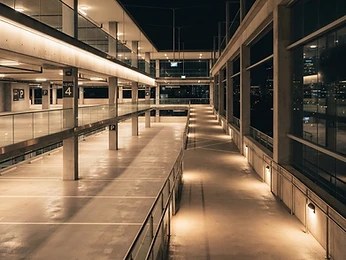 A well-lit upscale parking structure at night
