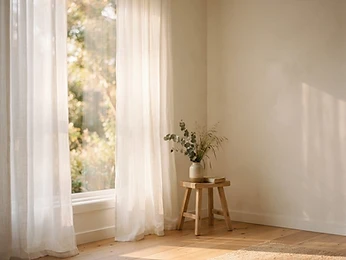 Soft sunlight through white curtains
