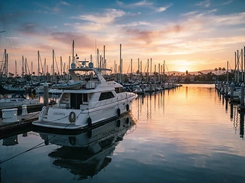 White boat in a calm marina at sunset