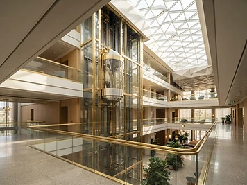 Polished glass elevator in a bright atrium