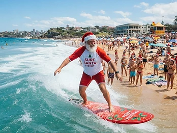 Christmas in 32 degrees — Santa hangs ten at Bondi.