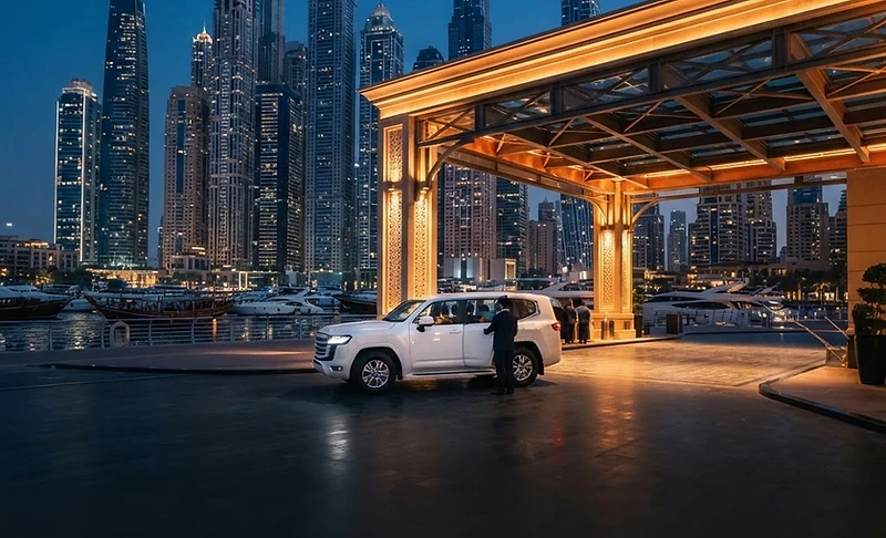 Safari pickup car waiting at a Dubai Marina hotel at dusk