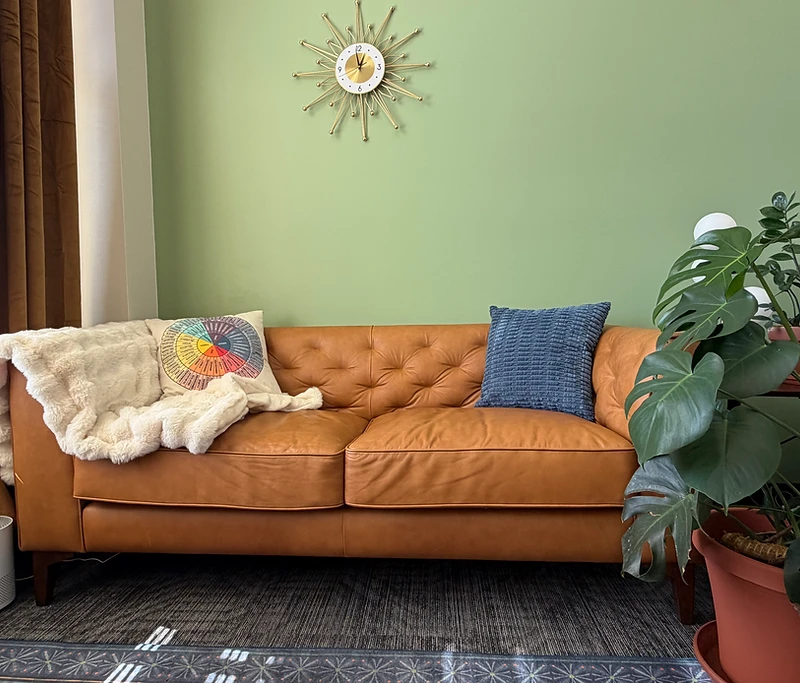 Therapy seating area with a warm leather sofa and soft natural light