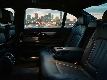 Clean car back seat with city lights through the window