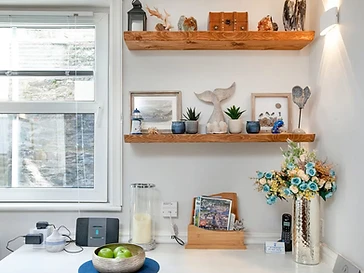 Floating oak shelves full of seaside finds