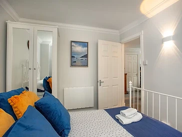 Mirrored wardrobes and a river print in the bedroom