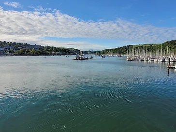 Yachts on their moorings the length of the estuary
