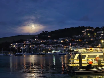 Moonlight on the river at dusk, with the ferry pontoon in the foreground