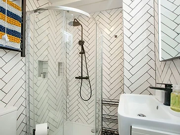The walk-in shower room with a rainfall shower and heated towel rail
