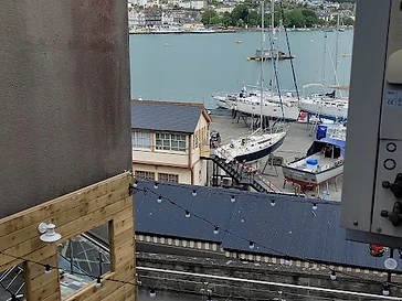 The side view from the bedroom window: lean out for the marina, the Dart and Dartmouth beyond