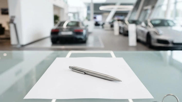 A quote sheet, pen, and car keys on a desk