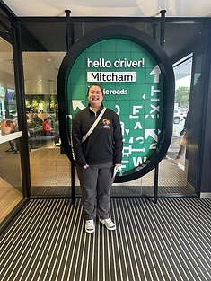 A happy Green Signals Driving School student holding their VicRoads congratulations certificate after passing at Mitcham.