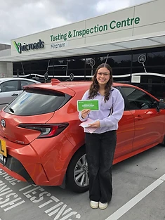 A happy Green Signals Driving School student holding their VicRoads congratulations certificate after passing at Mitcham.