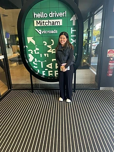 A happy Green Signals Driving School student holding their VicRoads congratulations certificate after passing at Mitcham.
