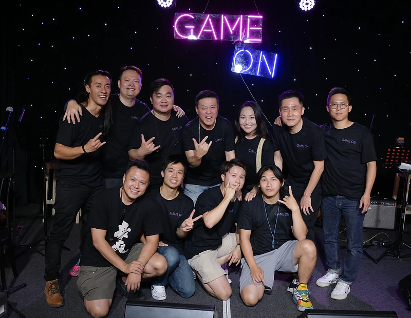 GAME ON performing live under their neon sign in front of a Brisbane audience