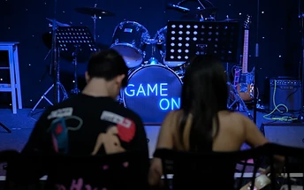 GAME ON stage with neon sign at a live concert