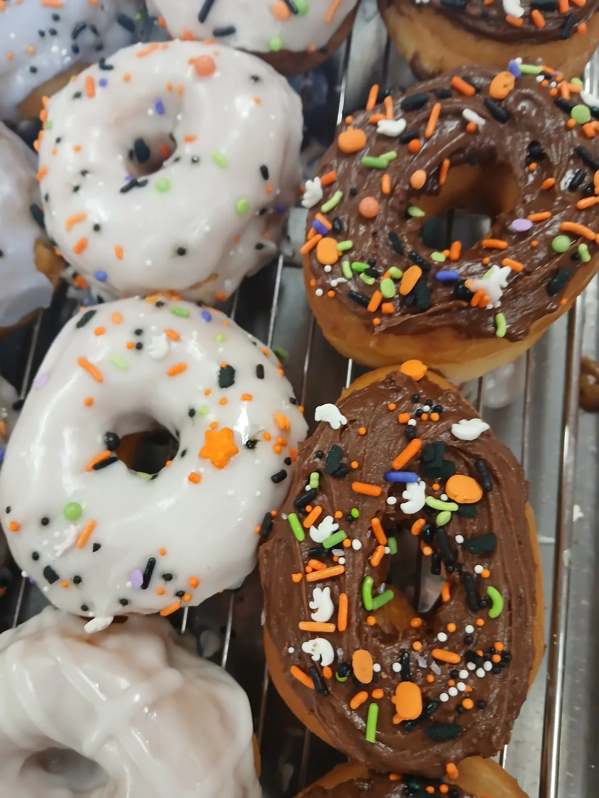Halloween donuts finished with orange, black and purple sprinkles