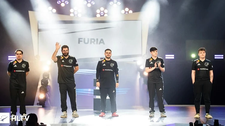 The FURIA lineup standing on stage in front of a screen showing the team name.