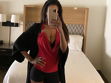 Mistress Prisscilla reflected in a low-lit mirror