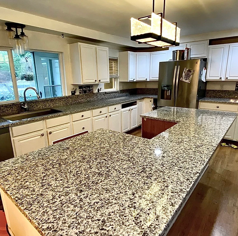 Marble waterfall island in a stone-tailored kitchen