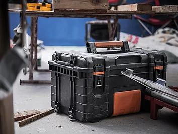 A heavy-duty tool case on a workbench in a workshop.