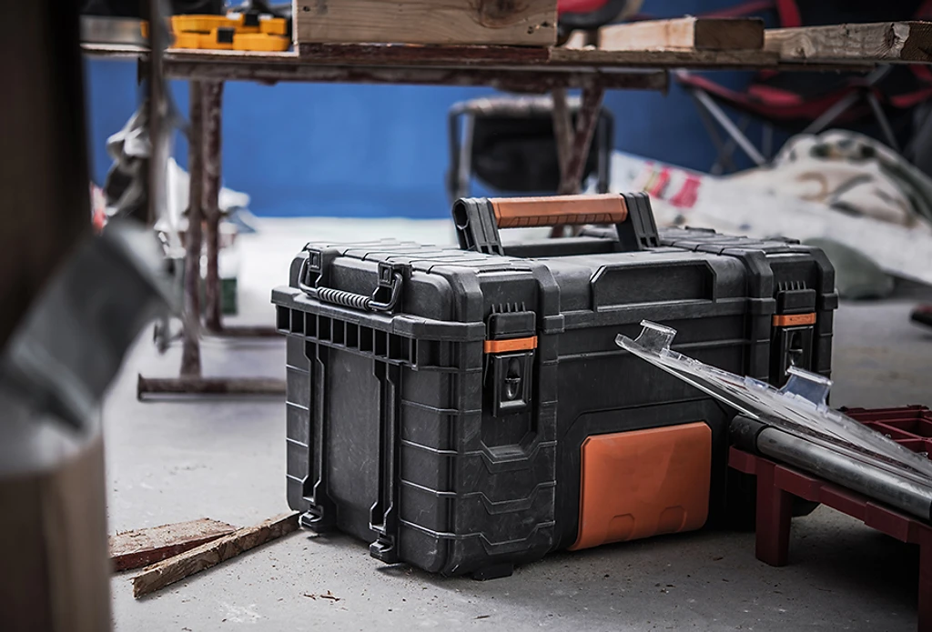 A heavy-duty tool case on a workbench in a workshop.