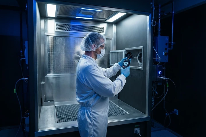 ABE technician measuring airflow with a digital anemometer