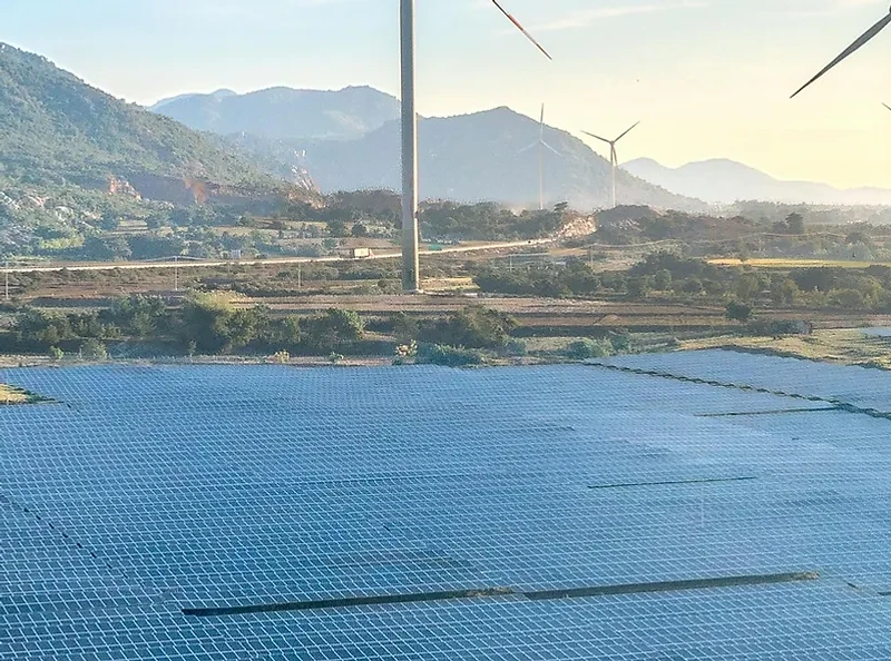 Solar panels and wind turbines in a landscape