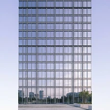Minimalist architectural facade against a pale lavender sky