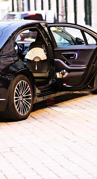 Open rear door of a Mercedes S-Class, refreshments on board