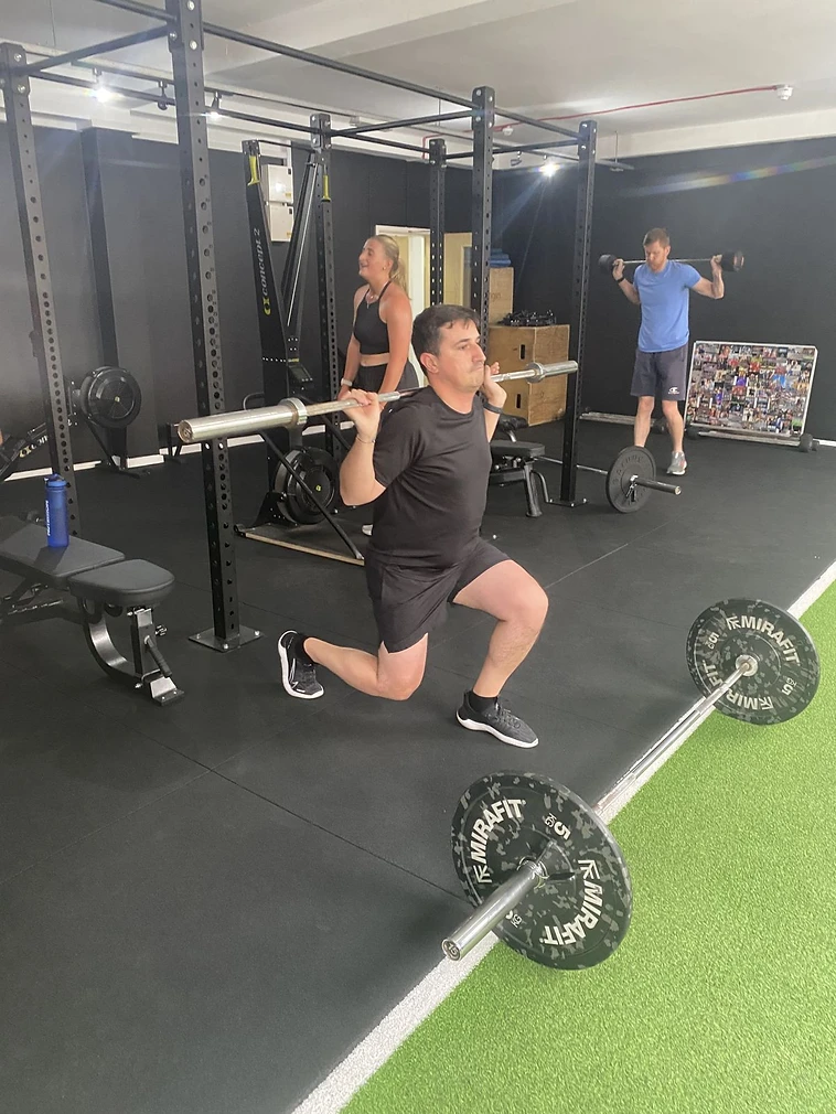 Member doing barbell lunges in a BUILD session at Crew42