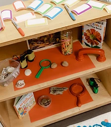 Discovery shelf with magnifying glasses and shells