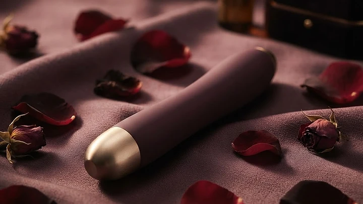 A premium intimate product on dark silk with rose petals