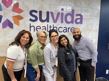 Cumbre Group founder with community health partners at a Suvida Healthcare clinic