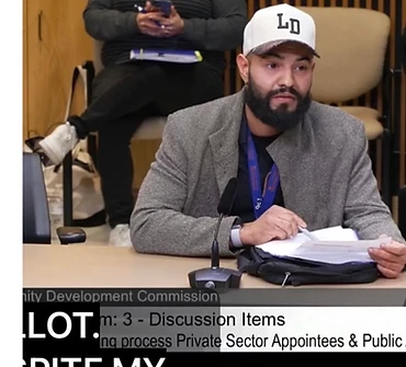 Cumbre Group founder speaking during a city Community Development Commission meeting