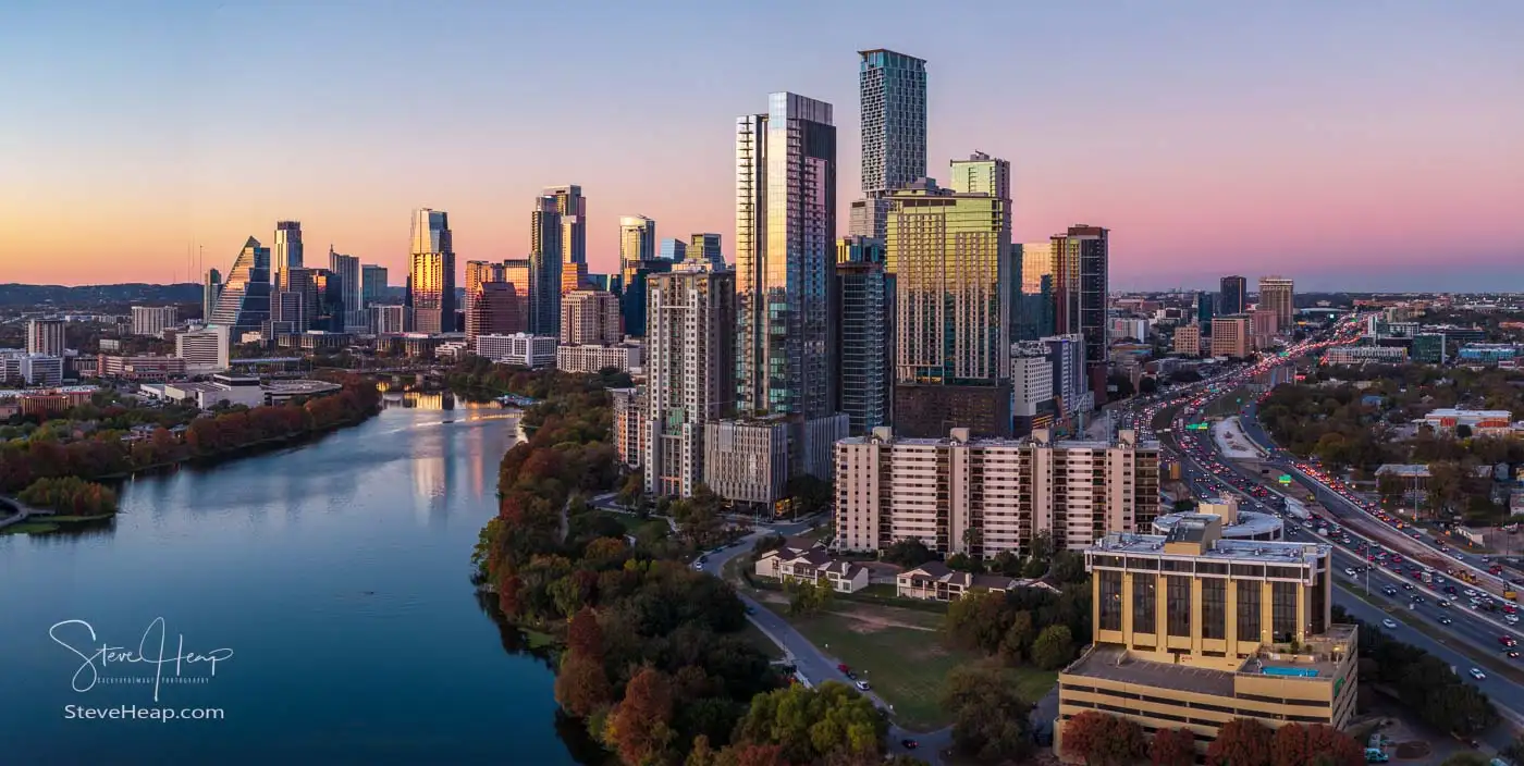 Austin, Texas downtown skyline at dusk, viewed over the Colorado River with downtown towers and I-35 traffic