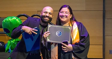 Cumbre Group founder congratulating a YouthBuild graduate at commencement