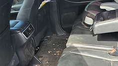 Rear passenger interior with child seat before detailing at GetRight Detailing in South Hackensack NJ