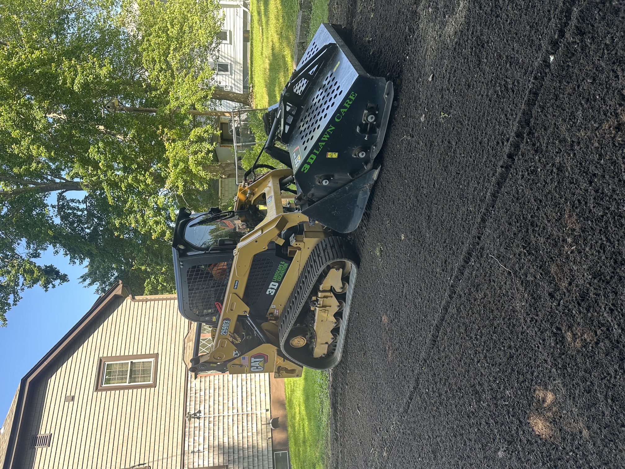 Forestry mulching machine clearing and preparing a wooded Rhode Island lot for new lawn installation