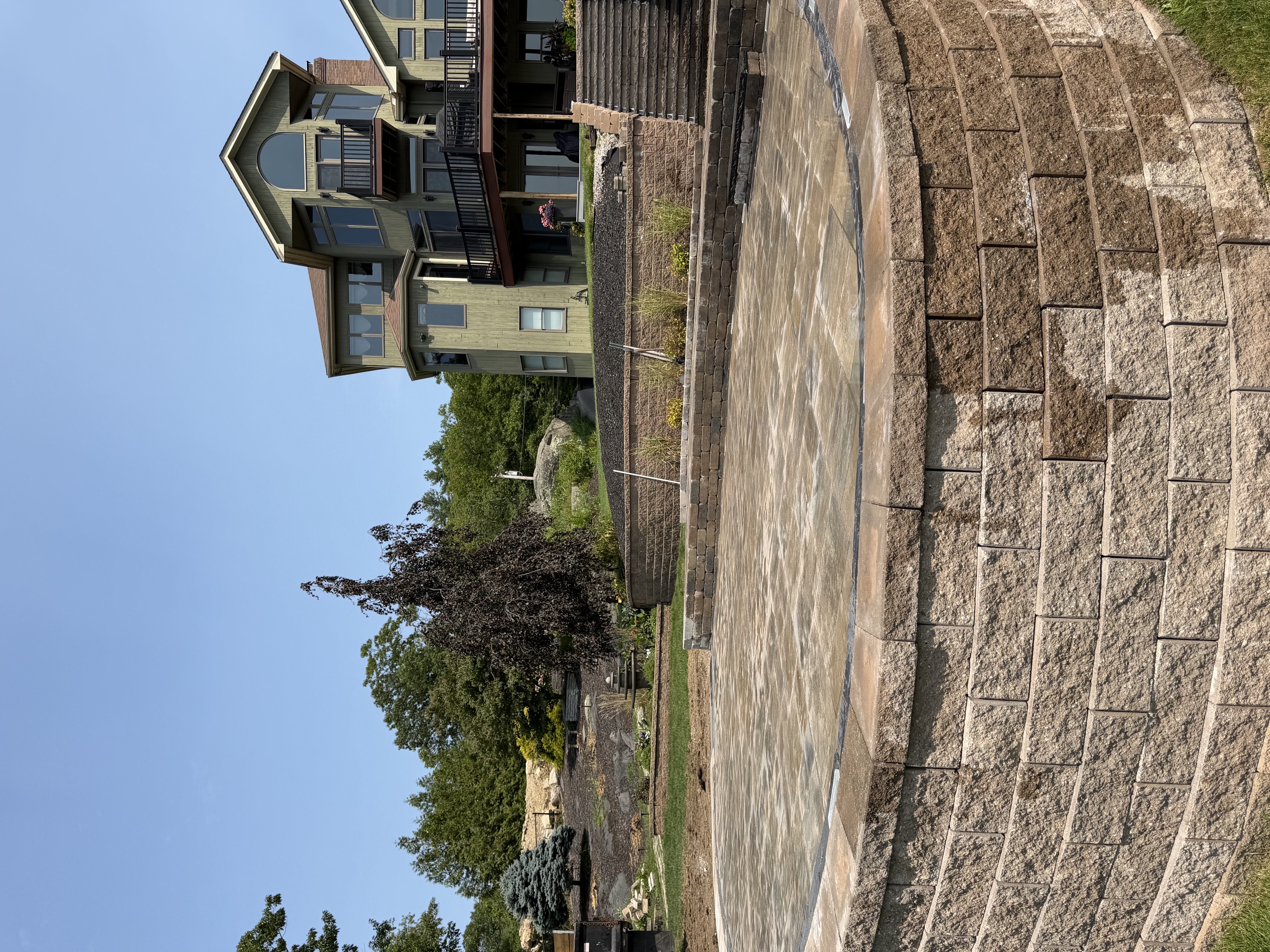 Segmental block retaining wall built along a sloped residential property in North Smithfield, RI
