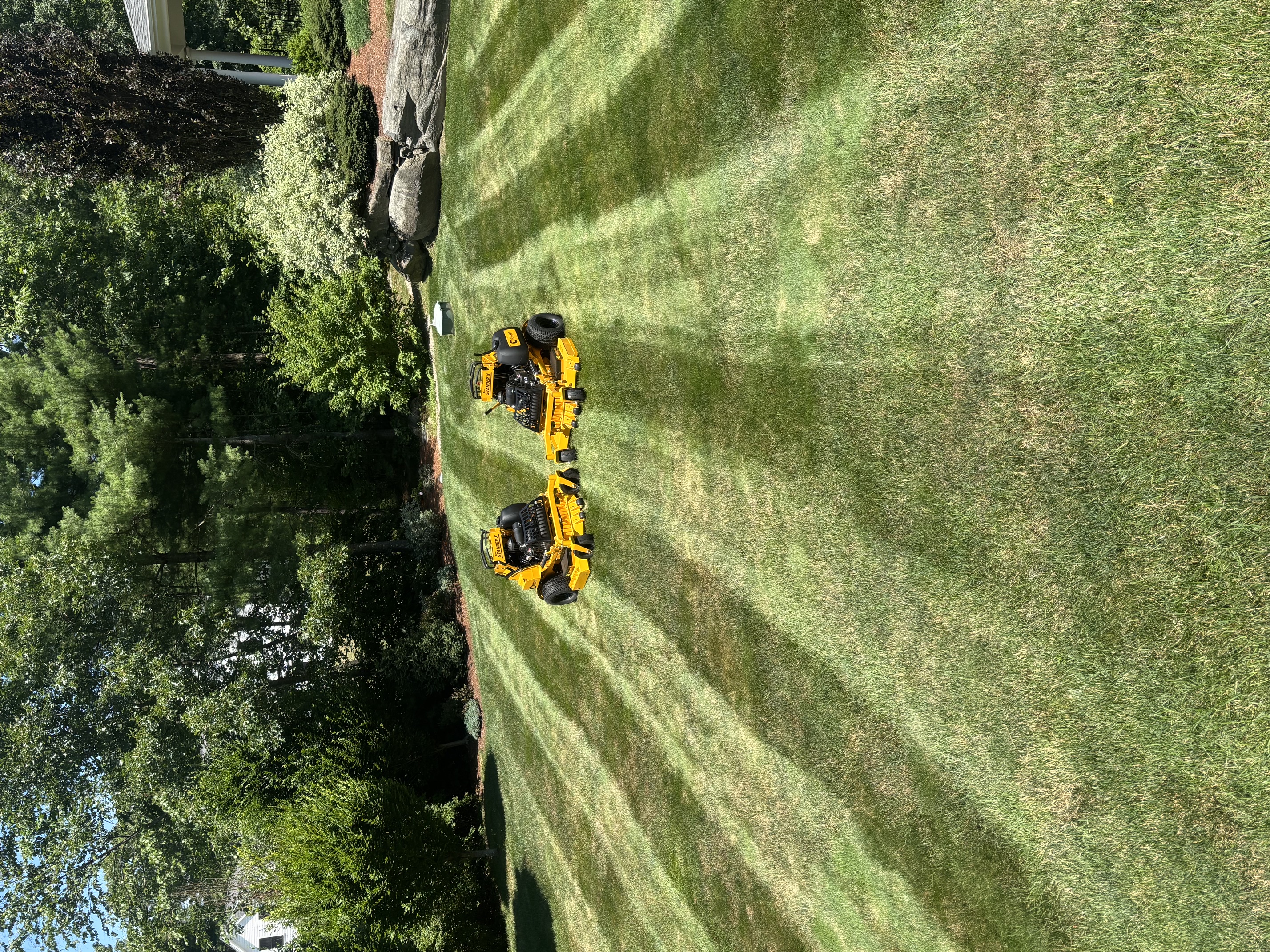 Commercial lawn mowing on a large open commercial property in North Smithfield, RI
