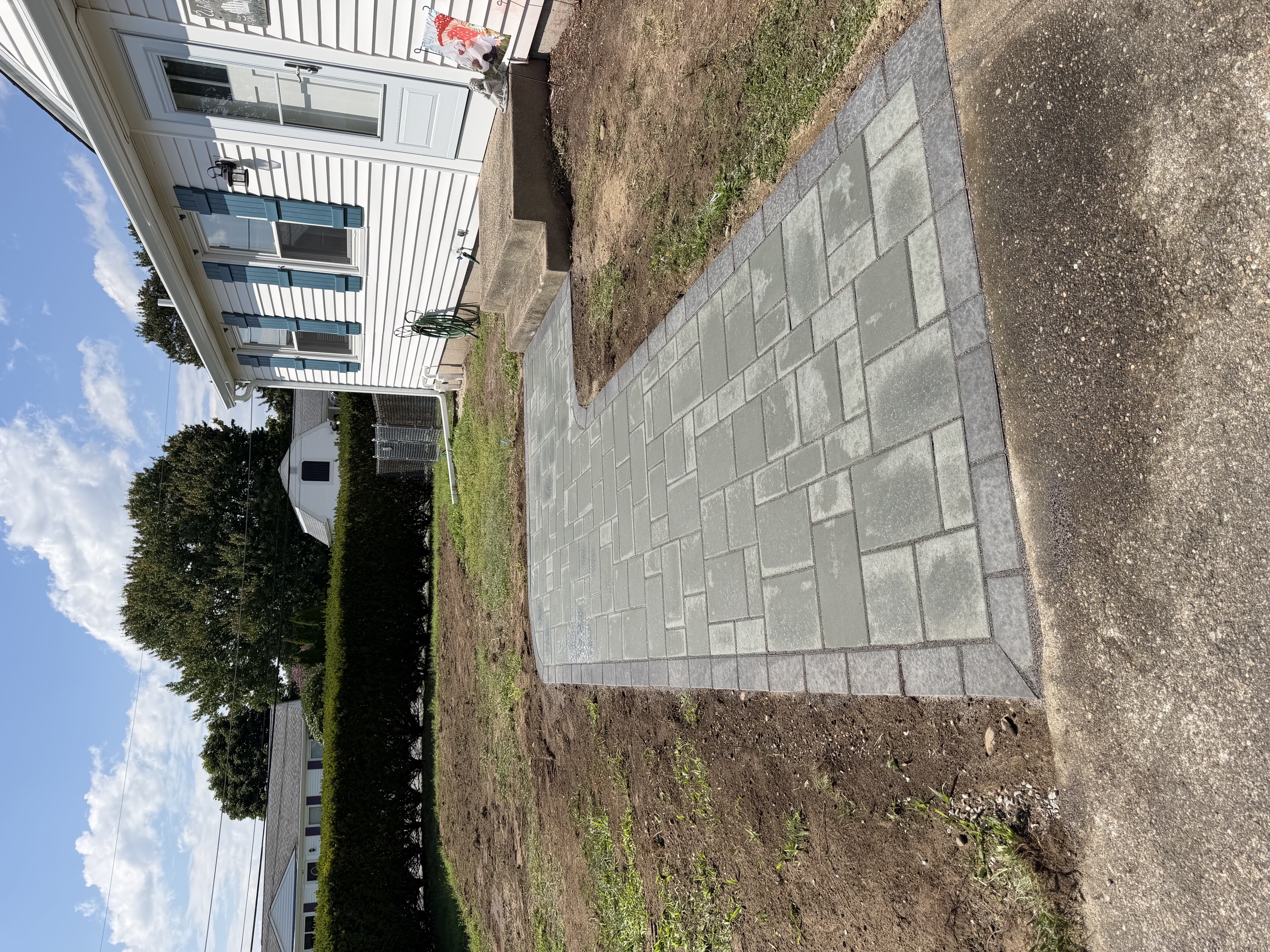 Newly installed paver walkway leading to a home entrance in North Smithfield, RI