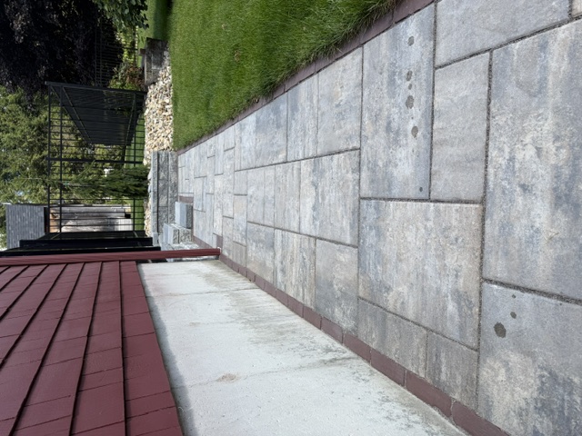 Gray paver walkway with soldier-course border running along the side of a house in North Smithfield, RI
